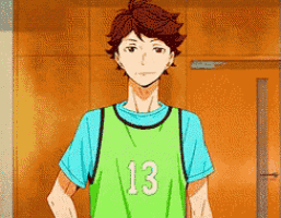 a man wearing a green jersey with the number 13 on it .