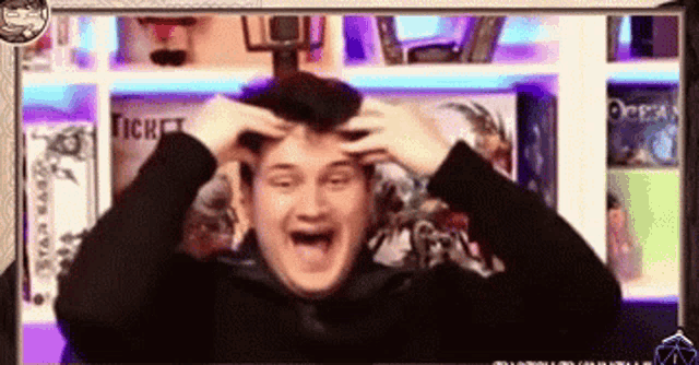 a man is making a funny face with his hands on his head in front of a sign that says ticket
