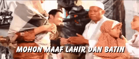 a group of people standing next to each other with the words " mohon maaf lahir dan batin " written in white letters