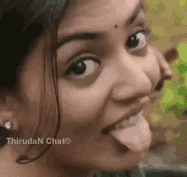 a close up of a woman sticking her tongue out