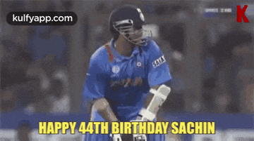 a cricket player is hitting a ball on a field while a pepsi ad is behind him .