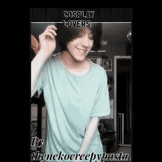 a boy with short hair is wearing a blue shirt and smiling .