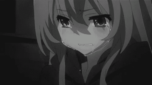 a black and white photo of an anime girl crying .