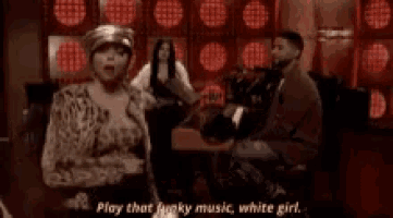 a woman is standing in a dark room and saying play that funky music white girl .