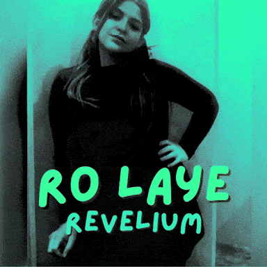 a woman stands in front of a sign that says ro laye revelium