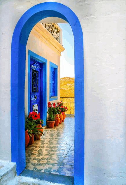 a blue archway leads to a blue door