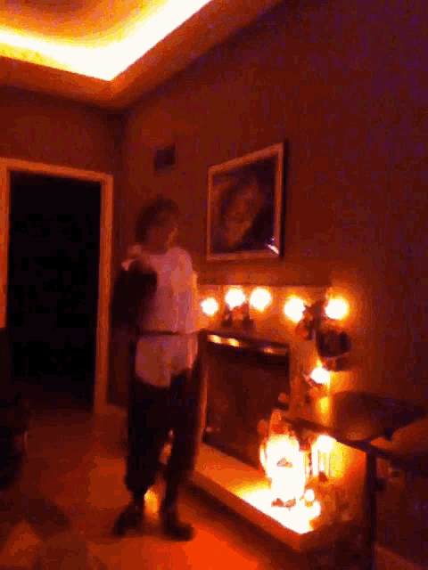 a woman is dancing in a dark room