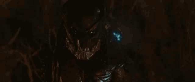 a close up of a monster with a blue light coming out of its eyes .