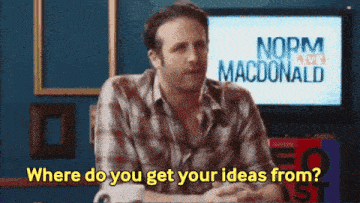 a man is sitting in front of a norm macdonald sign