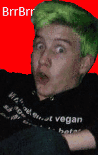 a person with green hair is wearing a black shirt that says vegan on it