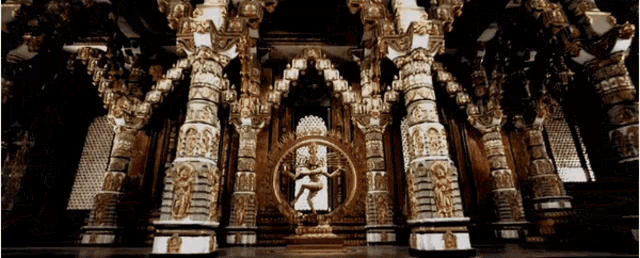 a temple with columns and a statue of a man