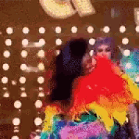 a blurry picture of a woman in a rainbow costume