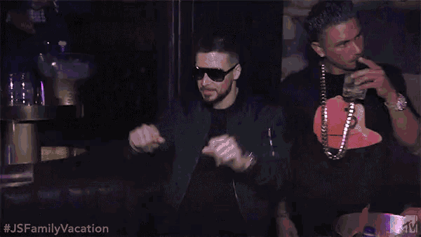 two men are dancing in a club with purple lights behind them and the words js family vacation on the bottom