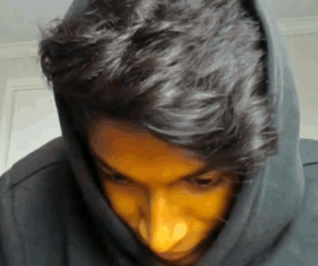 a close up of a man wearing a hoodie