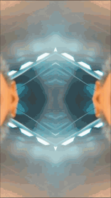 a kaleidoscope of a person 's face is displayed on a dark background