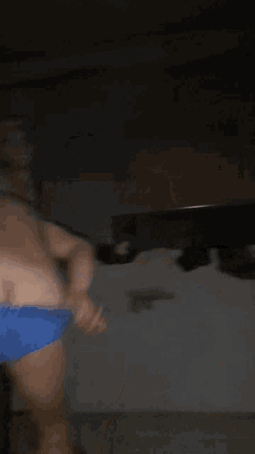 a blurry picture of a man in blue underwear