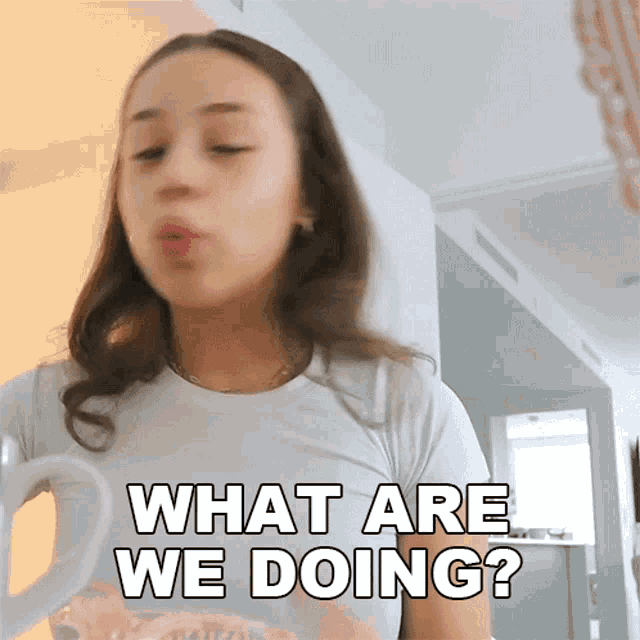 a girl is holding a coffee mug and says what are we doing