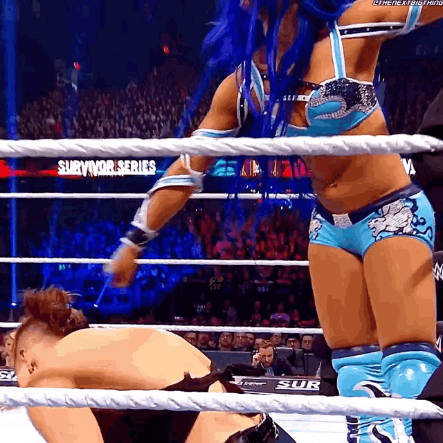 a woman in a wrestling ring with the word survivor series on the side