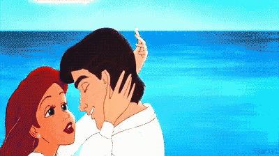 a cartoon of a man and a woman kissing on the beach .