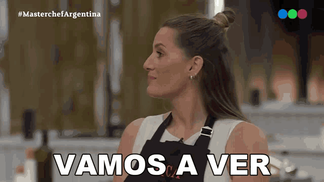 a woman in an apron says " vamos a ver " in spanish