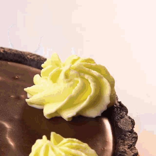 a swirl of yellow frosting on a chocolate cake