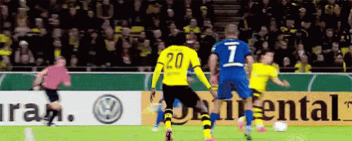 a soccer player with the number 20 on his jersey kicks the ball