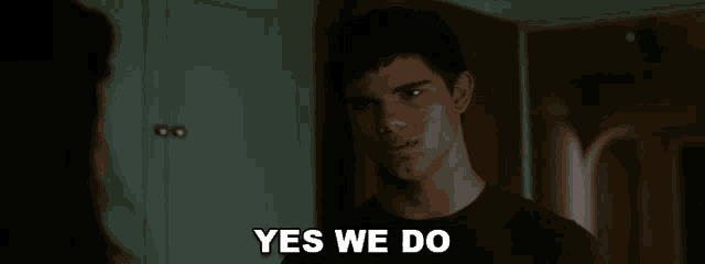 a man says yes we do in front of a wall