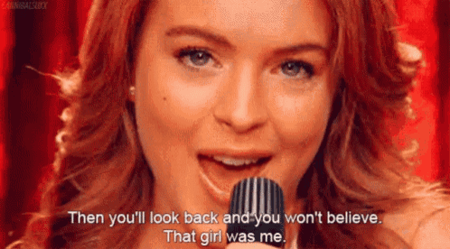 a woman is singing into a microphone with the words then you 'll look back and you won 't believe that girl was me