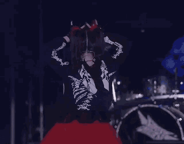 a woman wearing a skeleton costume is smiling