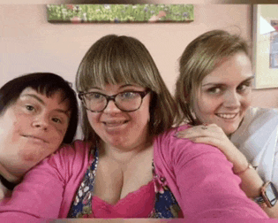 three women are posing for a picture and one has glasses