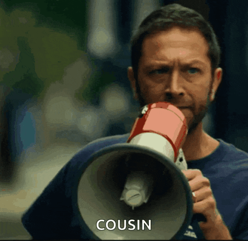 a man is holding a megaphone with the word cousin written on it