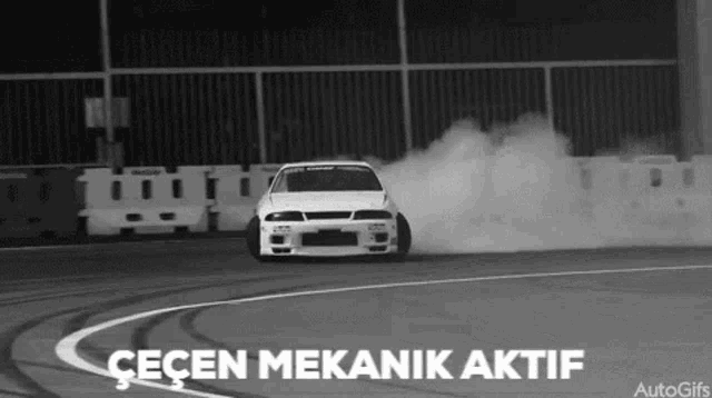 a black and white photo of a car drifting on a track with the caption " geçen mekanik aktif "
