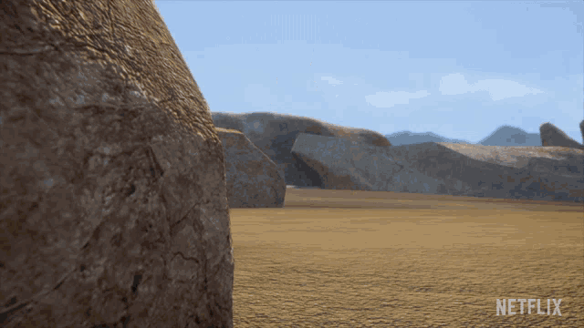 a netflix ad shows a desert landscape with rocks in the foreground