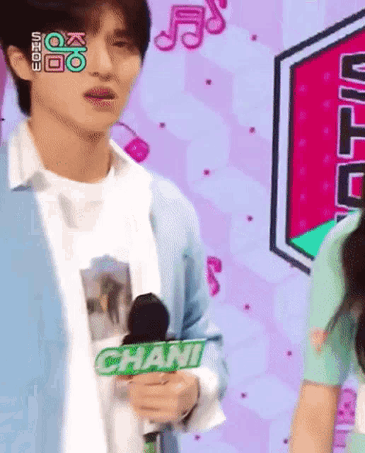 a man is holding a microphone with the name chani on it