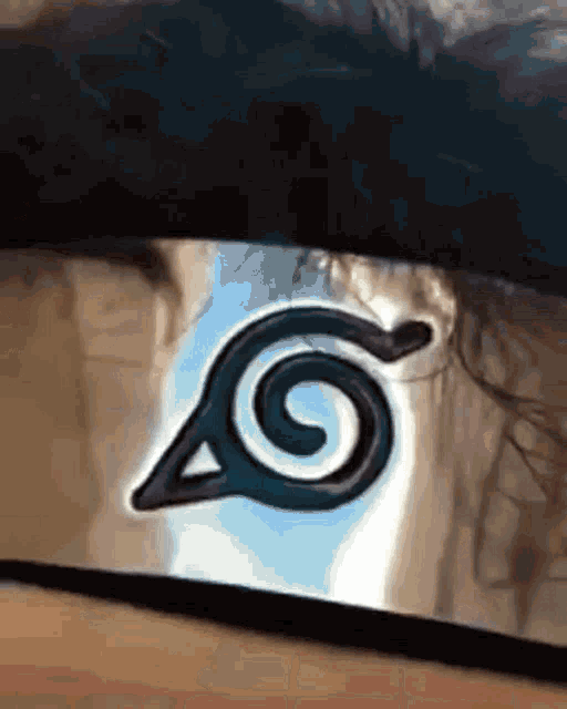 a close up of a naruto headband with a blue background