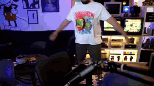 a man wearing a shirt that says " spongebob " is dancing in a living room
