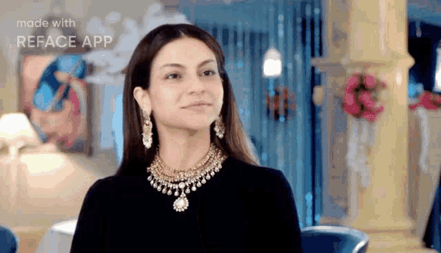 a woman wearing a necklace and earrings is smiling in a room made with reface app .
