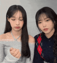 two girls are standing next to each other with one wearing a plaid shirt