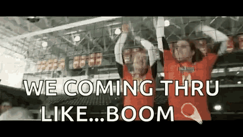 two volleyball players are holding up their arms in the air .
