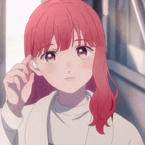 a girl with red hair is wearing a pair of earbuds
