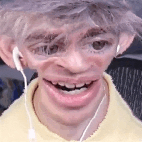a man is wearing headphones and making a funny face with his mouth open .