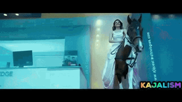 a woman in a white dress is riding a horse with the website www.ajquest-technologies.com in the corner