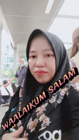 a woman wearing a black hijab with waalaikum salam written on the bottom