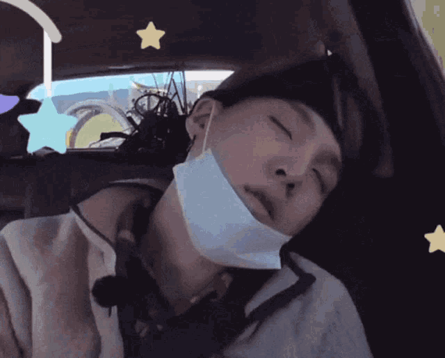 a man wearing a mask sleeping in a car