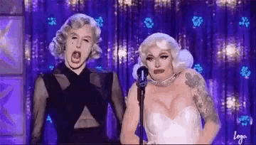 a man and a woman are standing next to each other on a stage .