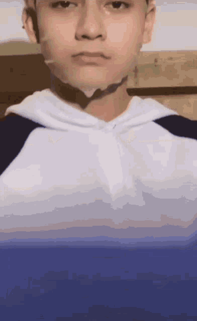a close up of a person 's face with a blue background .