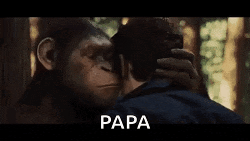 a man and a monkey are looking at each other and the monkey is talking to the man .
