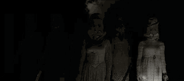 a group of women in white dresses and masks are standing in a dark room