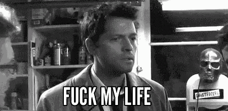 a man in a suit and tie is standing in front of a skull and says `` fuck my life '' .