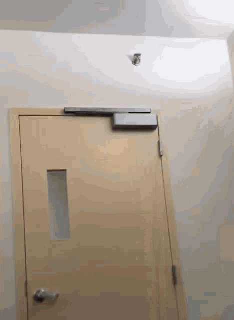 a close up of a door with a small window on it